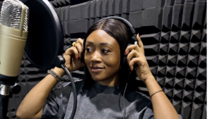 African voiceover artist and international voice actor Eniola Keshinro recording in a professional voiceover booth, wearing headphones and speaking into a studio microphone for a global brand campaign.African voiceover artist and international voice actor Eniola Keshinro recording in a professional voiceover booth, wearing headphones and speaking into a studio microphone for a global brand campaign.